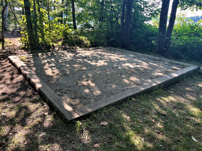 K1 Tent pad #3 at campsite with a couple of picnic tables in the background.