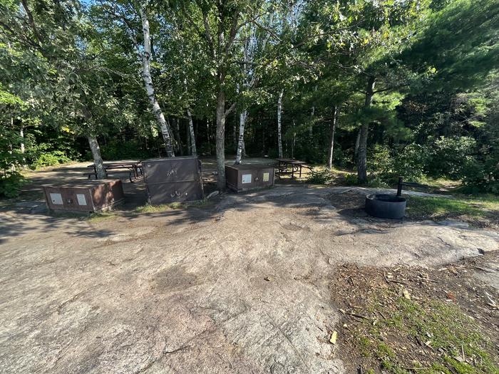 K1 View looking into campsite core of the fire ring bear lockers picnic tables and tent pads in the background.