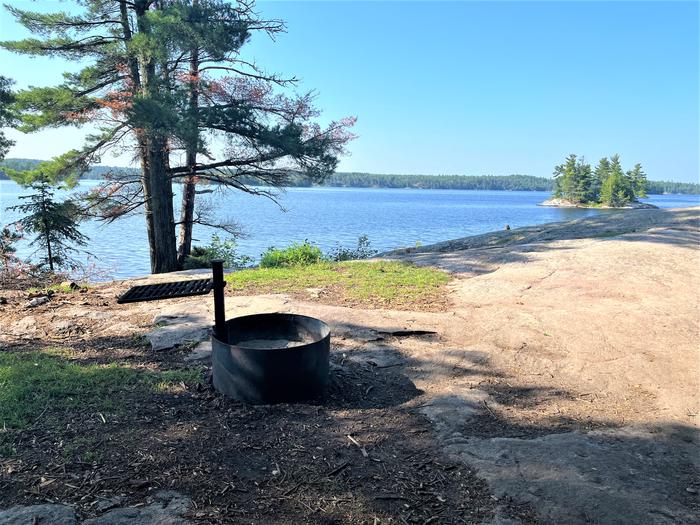 K1 View looking out from campsite of the fire ring with water and an island in the background.