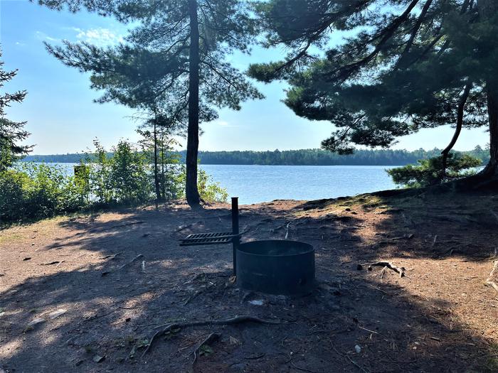 K7 View looking out from campsite of the fire ring with water in the background.