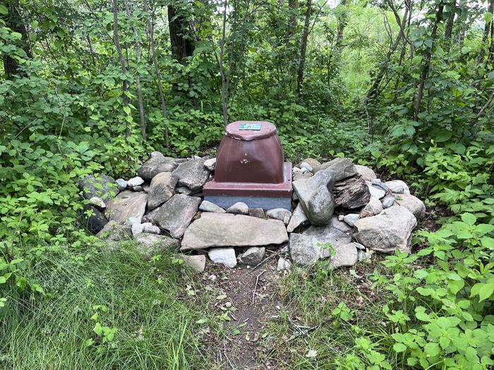 K11 Happy Landing privy at campsite with the toilet surrounded by rocks.