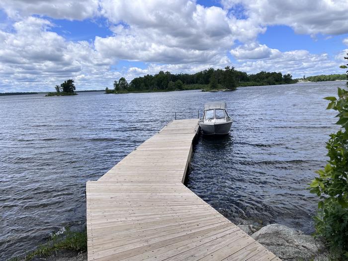 K11 Happy Landing view of dock landing from shore with a boat tied to the dock