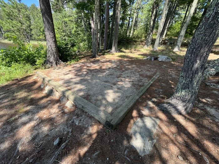 K17 Tent pad #1 as campsite surrounded by tall trees