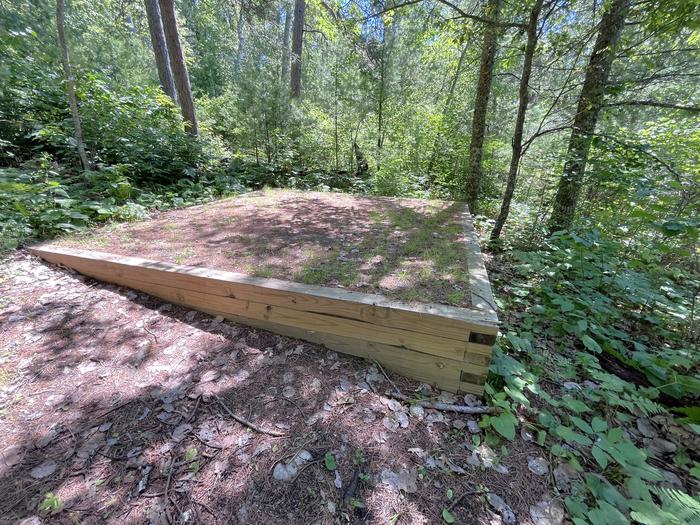 S12-C Mukooda Lake Crappie campsite tent pad #1 with greenery in the background