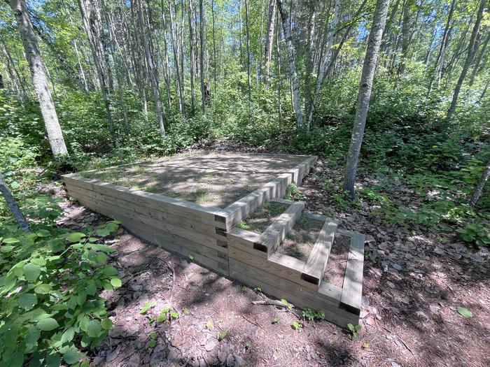 S12-C Mukooda Lake Crappie campsite tent pad #2 with a couple of steps with tall trees in the background