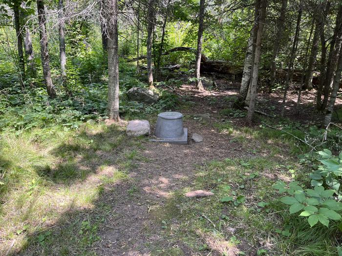 K24 Privy at campsite with trees in the background.