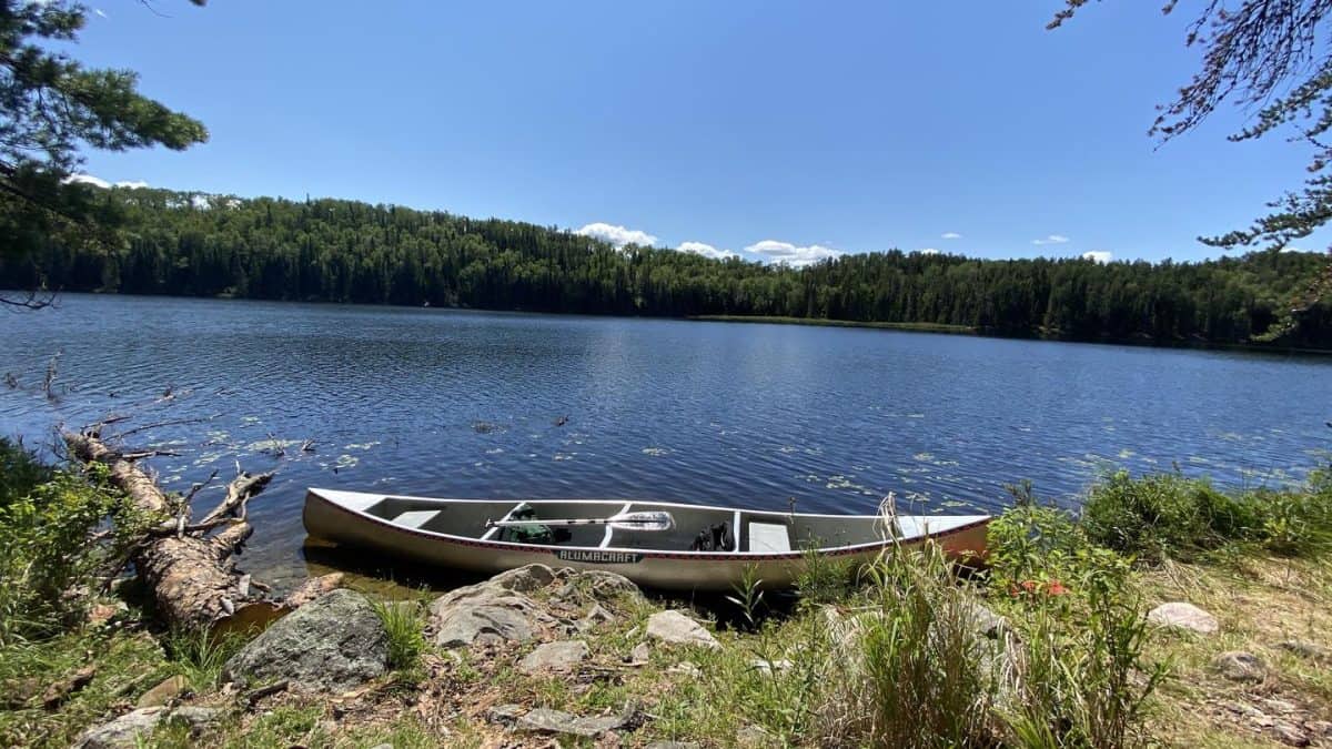 B17 Canoe pulled up to shore at War Club campsite